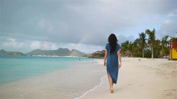 Young beautiful woman having fun on tropical seashore. video