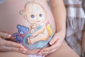 Nice drawing on the stomach of a pregnant woman photo