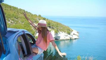 Little girl on vacation travel by car background beautiful landscape video