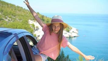 Little girl on vacation travel by car background beautiful landscape video