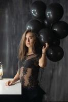 Elegance young brunette posing near a table photo