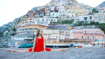 Adorable little girl on warm and sunny summer day in Positano town in Italy video