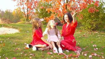 Little girl with mom outdoors in park at autumn day video