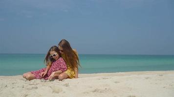 Family fun on white sandy beach. Mother and little kid enjoy summer vacation