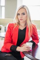 Alluring young blonde posing in a cafe photo