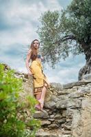 Lovely lady posing among antique ruins photo