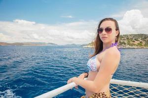Pretty woman posing on a yacht photo