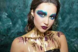 Young beautiful woman with creative make up photo