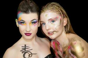 Two pretty young women with creative make-up photo