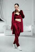 Cute brunette dressed in a burgundy velour suit photo