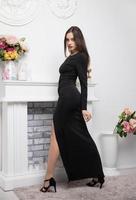 Charming young brunette wearing in a long evening dress photo