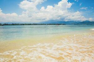 Calm surf on the beach on a sunny day photo