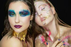 Two sexy young women with creative make-up photo