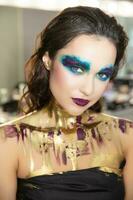 Cute young brunette with creative make up photo