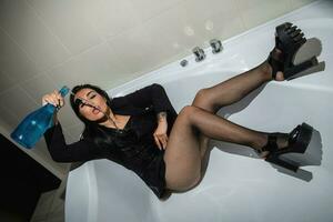 Alluring woman posing in a bathtub photo