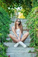 Young pretty brunette posing outdoors photo