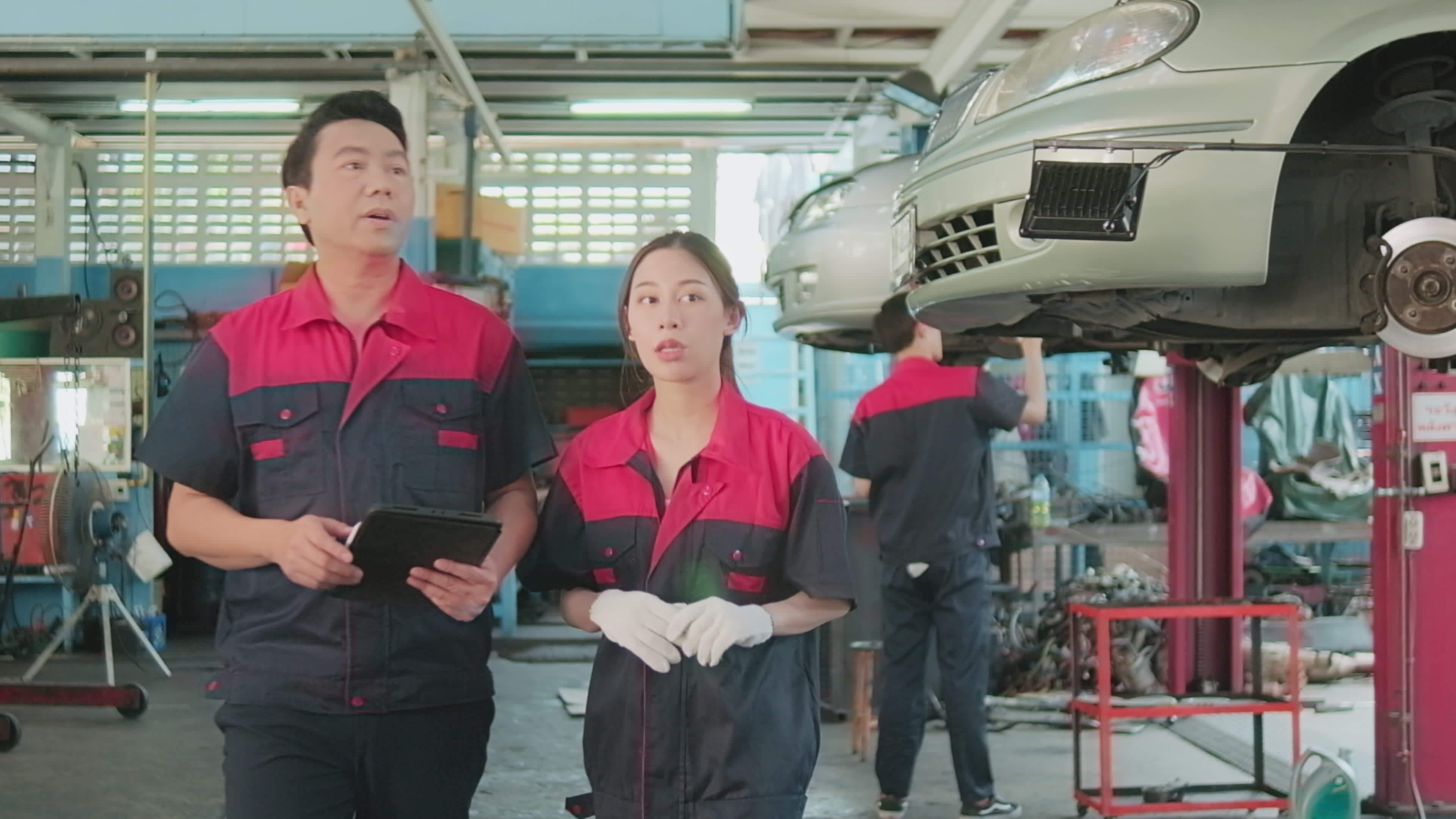 Professional automotive supervisors' teams inspect repair work with