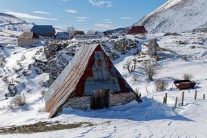 View of a mountain village during winter. Snow white landscape and mountaineer lifestyle. photo