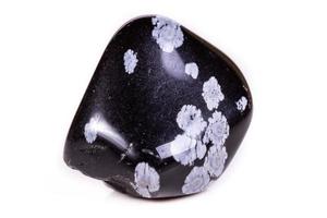 Macro mineral stone snow obsidian on white background photo
