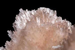 Macro mineral Scolecite stone on a black background photo