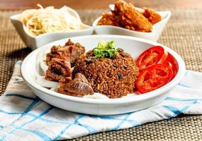 jollof rice with mean - vegetable and fruits photo
