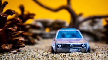 Minahasa, Indonesia  December 2022, the toy car among the pine cones photo