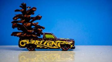 Minahasa, Indonesia  December 2022, the toy car transporting pinecones photo