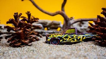 Minahasa, Indonesia  December 2022, the toy car among the pine cones photo