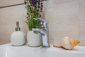 decorations in the interior of the bathroom with candles, flowers, wreaths and towels photo