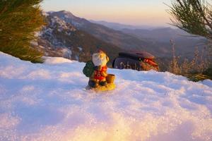 santa lies in the snow on the background of christmas treeswinter background selective focus photo