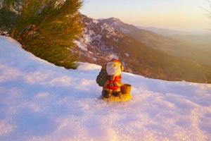 santa lies in the snow on the background of christmas treeswinter background selective focus photo