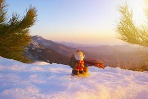 santa lies in the snow on the background of christmas treeswinter background selective focus photo