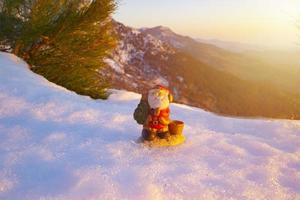 santa lies in the snow on the background of christmas treeswinter background selective focus photo