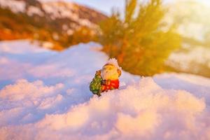 santa lies in the snow on the background of christmas treeswinter background selective focus photo