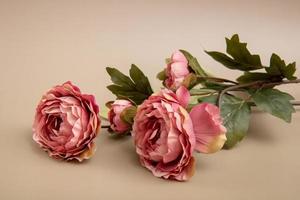 artificial flowers on a beige background, obituary background photo