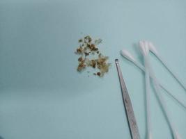 Earwax, earwax, cotton swabs, on a light blue table photo