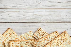 Concept of Jewish holiday Pesach. Passover. Traditional matzah on a white wooden background. Matzo bread. photo