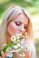 Beautiful blond woman in blue dress using smartphone to making selfie photo