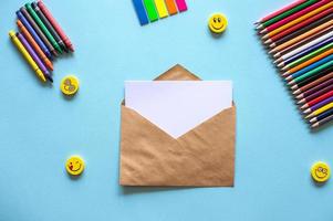 A set of bright stationery on a blue background. Kraft Envelope photo