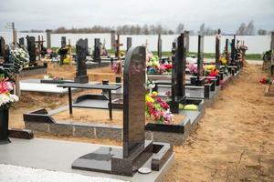 Grave crosses with wreaths in the cemetery on the sand photo
