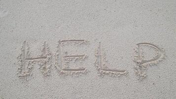 Help word writing on the sand at the beach as a relevant concept to your need. photo