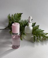 cosmetic bottle with tropical leaves. spa still life photo