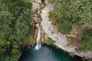 Waterfall in the middle of the forest photo