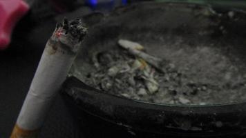 burning cigarette smoking with ashes photo