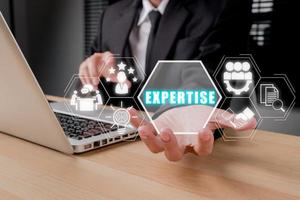 Expertise, expert, consulting, knowledge, team, advice, trust and research concept, Business person hand holding Expertise icon on virtual screen, Business and development. photo