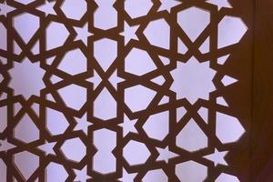 Silhouette of laser cut template panel with purple light. Arabian ornamental panel set. Silhouette or backlight ornament for background. photo