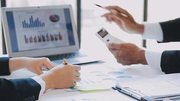 Financial analysts analyze business financial reports on a digital tablet planning investment project during a discussion at a meeting of corporate showing the results of their successful teamwork. video