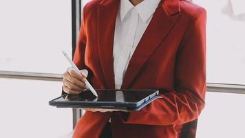 Financial analysts analyze business financial reports on a digital tablet planning investment project during a discussion at a meeting of corporate showing the results of their successful teamwork. video