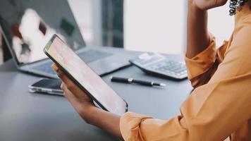 Financial analysts analyze business financial reports on a digital tablet planning investment project during a discussion at a meeting of corporate showing the results of their successful teamwork. video