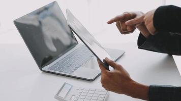 Financial analysts analyze business financial reports on a digital tablet planning investment project during a discussion at a meeting of corporate showing the results of their successful teamwork. video